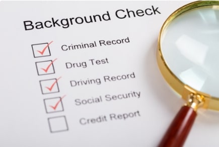 Background check checklist and magnifying glass