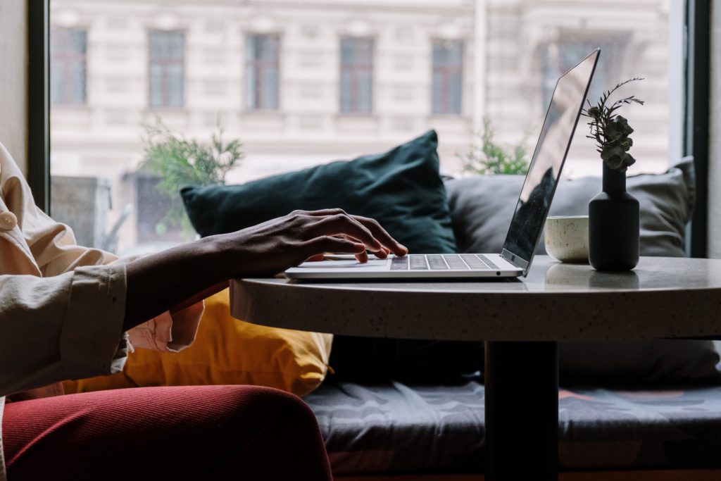 Hands operating a laptop