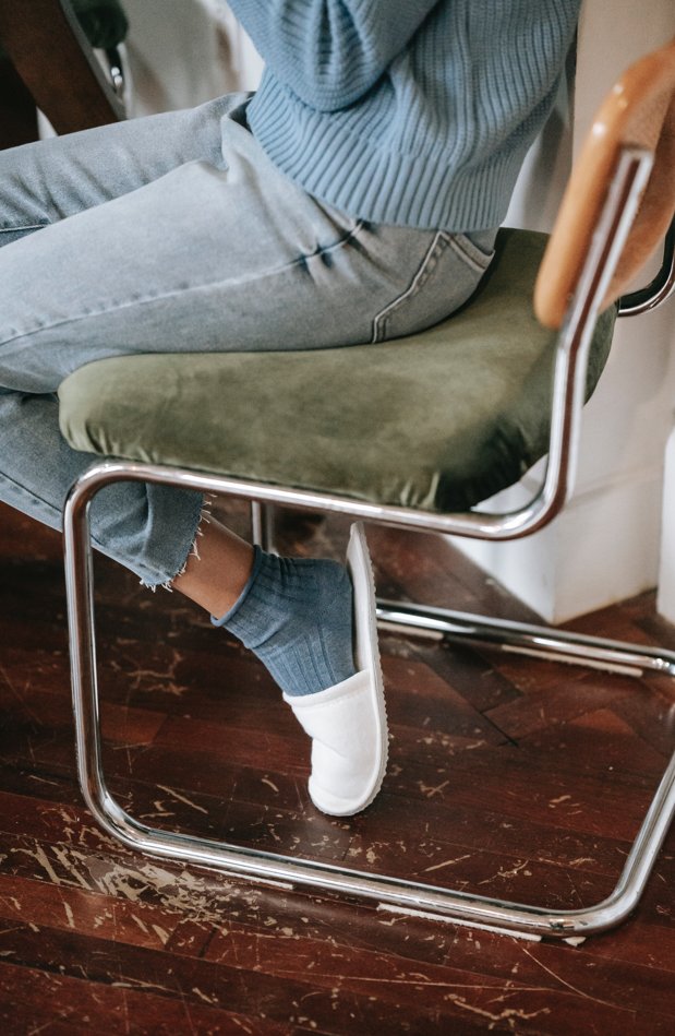 Person sitting on chair on scratched floor