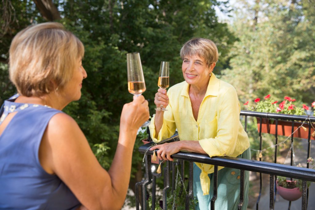 Neighbors on balcony having a chat