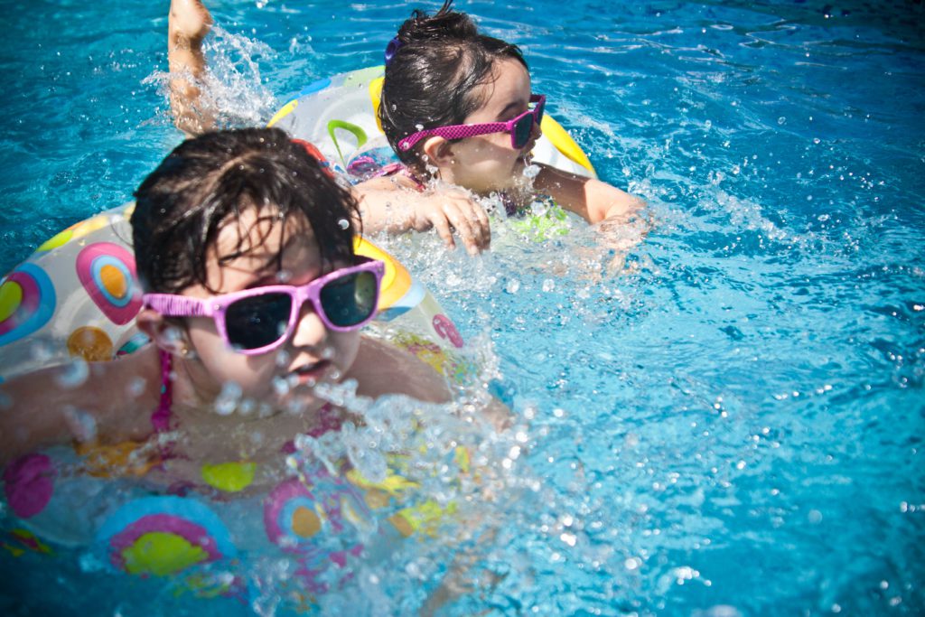 Two children play in a pool