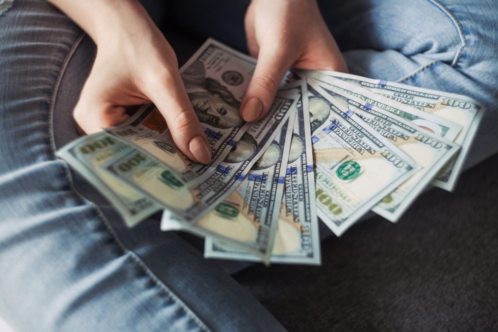 A man counting money to show the best policy for you