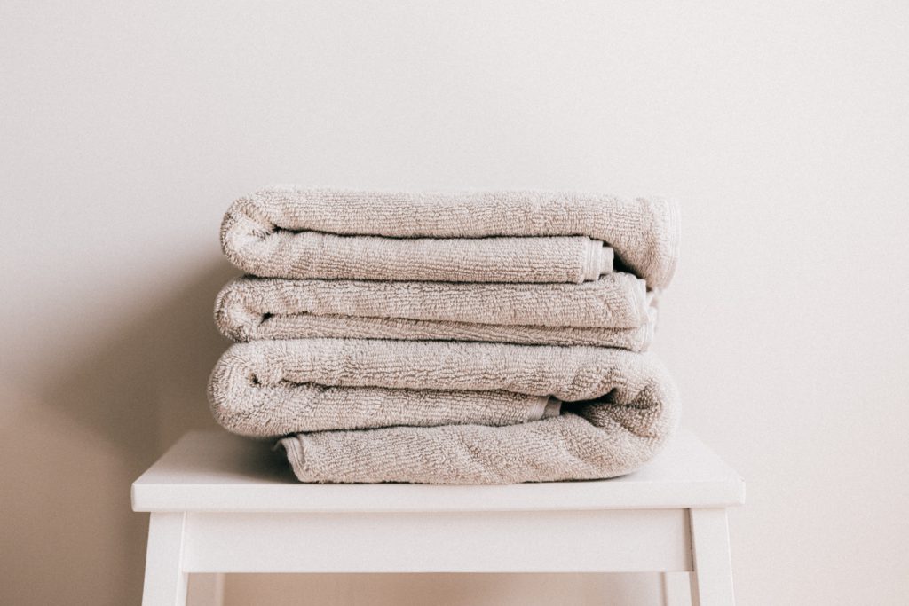 A photo of a pile of towels in a guest room
