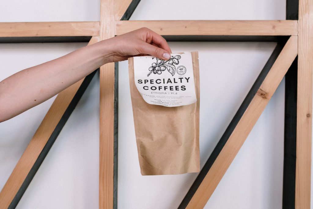 A photo of someone hoding a bag of locally roasted coffee